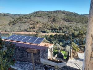 a house with a solar panel on the roof at Vilas da Matagosa in Matagosinha