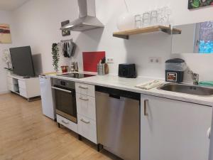 a kitchen with a sink and a stove top oven at Villa Bianca - Holiday & Business in Elsenfeld +17 photos