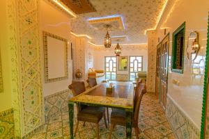 a dining room with a table and chairs at Colorful traditional Riad w/views of Spain in Tangier