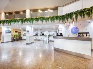 a lobby of a hospital with plants on the wall at Novotel Surfers Paradise in Gold Coast