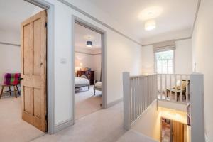 a hallway with a door leading to a bedroom at Perfect Cosy Cottage in Litcham
