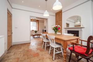 a dining room with a wooden table and chairs at Perfect Cosy Cottage in Litcham