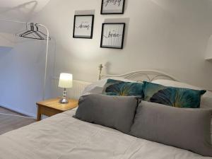a bedroom with a bed with three pictures on the wall at Keary Entire House. 3 beds. Bright and Cheerful. in Stoke on Trent