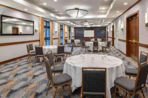 a conference room with tables and chairs and a podium at DoubleTree by Hilton San Francisco Airport in Burlingame