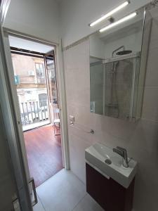 a bathroom with a sink and a mirror at Cortile dei Sogni in Catania