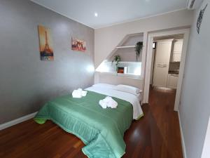 a bedroom with a bed with two towels on it at Cortile dei Sogni in Catania