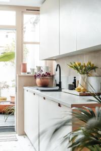 a kitchen with white cabinets and a counter top at Boutique Beach Retreat in Westward Ho