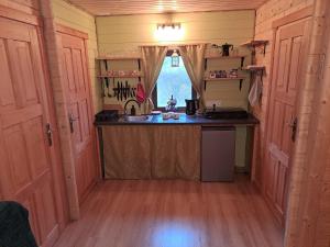 a kitchen with a sink and a counter in a house at Chatki Małgorzatki in Bystre