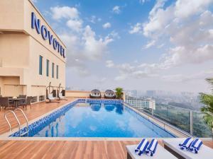 a swimming pool on the roof of a hotel at Novotel Mumbai International Airport in Mumbai