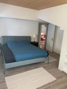 1 dormitorio con 1 cama con manta azul en DG Russi Bella Vista, en Andermatt