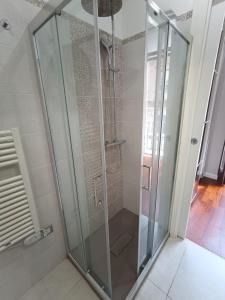 a shower with glass doors in a bathroom at Cortile dei Sogni in Catania