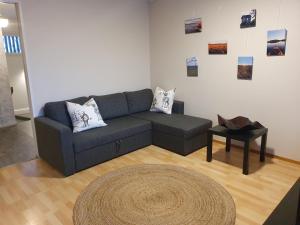 a living room with a couch and a table at Make yourself at home in Rovaniemi