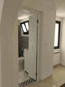 baño con bañera, aseo y ventana en Duplex Hammamet, en Hammamet