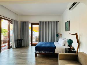 a bedroom with a bed and a couch at Soleil de An Bang Villa in An Bang +63 photos