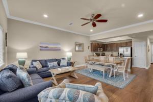 a living room with a couch and a table at Alerio B203 in Destin
