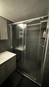 a shower with a glass door in a bathroom at Promenade city apartment in Thessaloniki