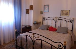 a bedroom with a bed with two red pillows at La casa di Silvia in Massarosa