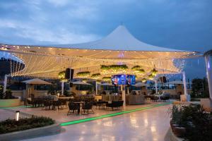 a large white tent with tables and chairs and lights at Argyle Grand Hotel Nairobi Airport in Nairobi