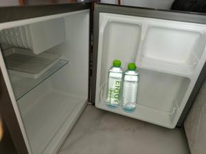 two bottles of water in an open refrigerator at MediLeaf Hostel in Haad Rin