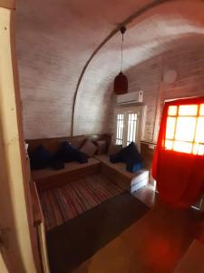 a living room with a couch and a window at Green Beach Camp & Hotel in Nuweiba