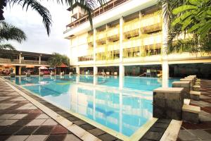 The swimming pool at or close to Nirmala Hotel & Convention Centre