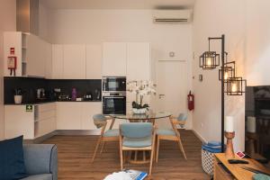 a kitchen and living room with a table and chairs at Varanda Azul - First Mate Loft (City Centre) in Ponta Delgada