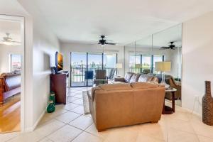 a living room with a couch and glass walls at Land's End 3-404 Bay Front in St Pete Beach