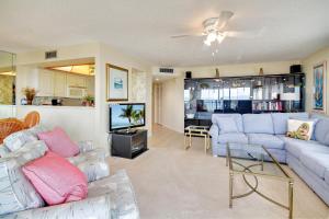 a living room with a couch and a tv at Land's End 8-401 Beach Front in St. Pete Beach