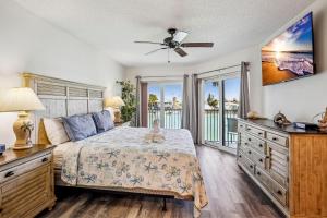 a bedroom with a bed and a view of the ocean at Land's End 3-205 Bay Front - Premier in St. Pete Beach