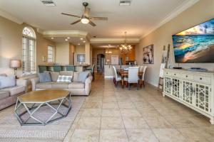 a living room with a couch and a table at Seaclusion Beach Townhome in St Pete Beach