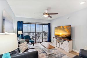 a living room with a couch and a flat screen tv at Villa Madeira 408 - Premier in St Pete Beach