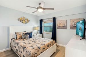 a bedroom with a bed and a ceiling fan at Villa Madeira 408 - Premier in St Pete Beach
