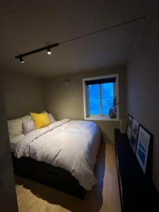 a bedroom with a large bed and a window at Koselig leilighet med havutsikt in Tromsø