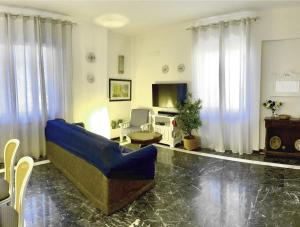 a living room with a blue couch and a tv at Andrew’s House in Ortona +16 photos