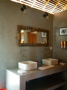 uma casa de banho com um lavatório e um espelho em ECOLODGE Diana em Ankify