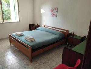 a bedroom with a bed with two towels on it at Villa Bianca in Ioppolo