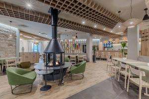 a restaurant with a fireplace in the middle of a room at Glіbіvka Family Park in Glebovka