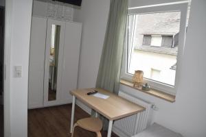 a small table in a room with a window at TKS HOME Zur Tenne 