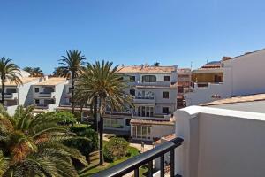 a view from the balcony of a building with palm trees at Apartamento Primera Linea de Playa. DENIA in Denia