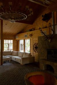 a living room with white couches and a stone wall at Glіbіvka Family Park in Glebovka