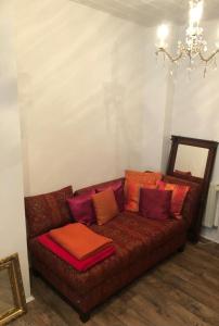 a brown couch with pillows on it in a room at Villa Adlon in Hochheim am Main
