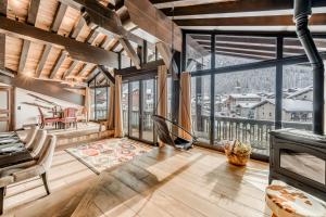 a living room with a view of the mountains at Hotel & Spa Le Val d'Isère in Val-d'Isère