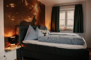 a bedroom with a bed with blue and white pillows at Wohnung Schrödelstein in Lenggries