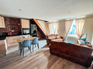 a living room with a couch and a table at Les Glycines in Guewenheim