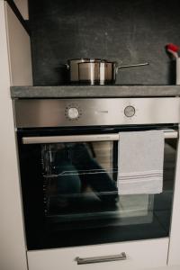 a pot is sitting on top of an oven at Wohnung Finstermünz in Lenggries