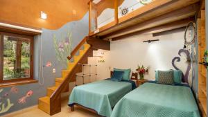 a bedroom with two beds and a staircase at Casa Samai Boutique in Samaipata