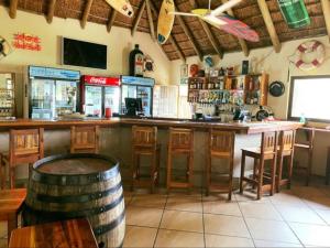 a bar with a barrel in the middle of a room at The Pont Home Owners in Port Edward