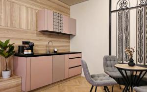 a kitchen with a sink and a table and chairs at Fadilpasic's House in Sarajevo
