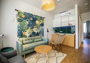 a living room with a couch and a table at Discovery Saipan Hotel in Garapan