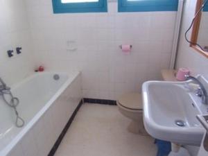 a bathroom with a tub and a toilet and a sink at Maison Spacieuse à Carnac - 4 Chambres, Terrasse et Jardin, Proche Plage et Commerces - FR-1-377-45 in Carnac